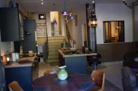 a kitchen with a table with a vase on it at Hôtel Saint Albert in Sarlat-la-Canéda