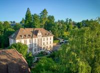 an aerial view of a large building with trees at Hotel Promenade in Schaffhausen