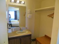 a bathroom with a sink and a mirror and a bed at Bryce View Lodge Part of the Ruby's Inn Resort in Bryce Canyon