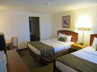 a hotel room with two beds and a table at Bryce View Lodge Part of the Ruby's Inn Resort in Bryce Canyon