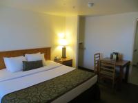 a bedroom with a bed and a desk with a lamp at Bryce View Lodge Part of the Ruby's Inn Resort in Bryce Canyon