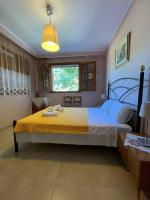 a bedroom with a large bed with a yellow blanket at Evak Chalet in Paleo Tsifliki