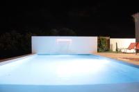 a swimming pool lit up at night at Les Villas des Fontaines in Saumane-de-Vaucluse