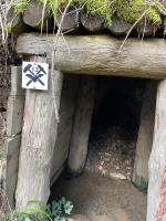 a cave with a sign on the side of it at Ferme De La Prairie D Hergauchamps mit Sauna und Whirlpool in Sainte-Marie-aux-Mines