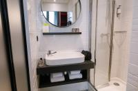 a bathroom with a sink and a shower at Hôtel de Noailles in Lyon