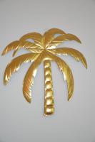 a gold palm tree sculpture on a white background at Huize Maurits in The Hague