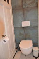 a bathroom with a white toilet in a room at Huize Maurits in The Hague