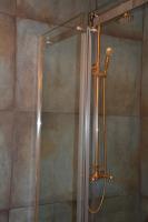 a shower with a glass door in a bathroom at Huize Maurits in The Hague