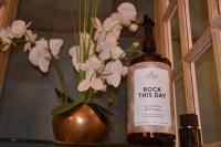 a bottle of wine next to a vase with flowers at Huize Maurits in The Hague