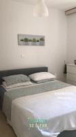 Łóżko lub łóżka w pokoju w obiekcie Marina Apartment