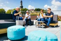 a group of people sitting on a patio with drinks at Das Mühlentor Hotel in Bad Kreuznach