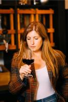 a woman holding a glass of red wine at Das Mühlentor Hotel in Bad Kreuznach