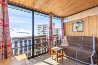 a living room with a couch and a large window at Résidence Le Sérac - Val Thorens in Val Thorens