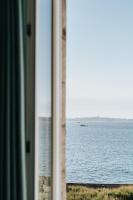 a view of the ocean from a window at Hôtel Aux Tamaris - Vue Mer in Roscoff