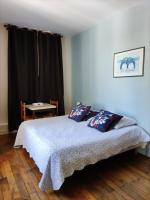 a bedroom with a bed with two pillows on it at Le Nid - Studios in Chartres