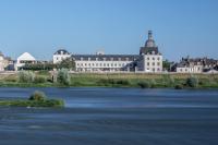 a view of a river with buildings in the background at Fleur de Loire in Blois