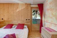 A bed or beds in a room at Baita dei ski app 2