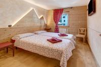 A bed or beds in a room at Baita dei ski app 2