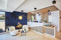 a salon with two chairs and a counter in a room at EDEN HÔTEL in Sainte-Maxime