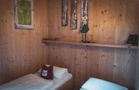 Posteľ alebo postele v izbe v ubytovaní Hüttendorf Hohentauern - Dein Feriendomizil in den Bergen