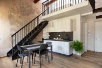 a kitchen and dining room with a table and chairs at Florentia Art Apartments in Florence