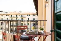 a table with glasses on a balcony with a view at Florentia Art Apartments in Florence