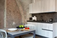 a kitchen with a table with fruits and vegetables on it at Florentia Art Apartments in Florence
