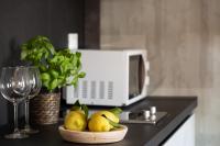 a bowl of pears on a counter next to a microwave at Florentia Art Apartments in Florence