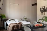 a bedroom with a bed and a table with a bowl of fruit at Florentia Art Apartments in Florence