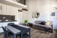 a kitchen and living room with a table and a couch at Florentia Art Apartments in Florence