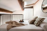 a bedroom with a large white bed with a mirror at Florentia Art Apartments in Florence