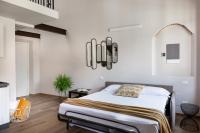 a bedroom with a bed and a chandelier at Florentia Art Apartments in Florence