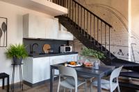 a kitchen and dining room with a table and chairs at Florentia Art Apartments in Florence