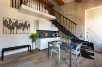 a kitchen and dining room with a black table and chairs at Florentia Art Apartments in Florence