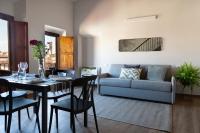 a living room with a table and a couch at Florentia Art Apartments in Florence