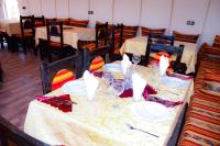 a table with plates and wine glasses on it at Relaxing Desert Camp in Merzouga