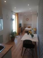 a kitchen and living room with a bed and a table at Studio neuf dans propriété au bord de la mer in Criel-sur-Mer