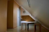 a room with a staircase with a bench and stool at Storchencamp Gästehaus Purbach in Purbach am Neusiedlersee
