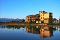 a building sitting next to a body of water at Full Sweet Inn in Wujie