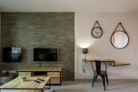 a living room with a clock on the wall at Appart cosy(4pers)PARKING CLIM Terrasse Vélodrome in Marseille