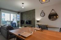 a dining room with a table and a clock on the wall at Appart cosy(4pers)PARKING CLIM Terrasse Vélodrome in Marseille