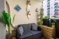 a patio with a couch and some plants at Appart cosy(4pers)PARKING CLIM Terrasse Vélodrome in Marseille
