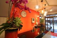 a lobby with a clock on the wall and flowers at Prince Hotel in Chiayi City