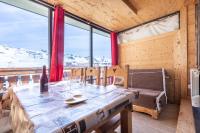 a dining room with a table and a view of snow covered mountains at Résidence Le Sérac - Val Thorens in Val Thorens