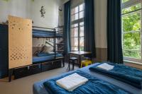 a bedroom with two bunk beds and a desk at Stayokay Hostel Amsterdam Vondelpark in Amsterdam