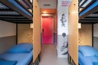two beds in a dorm room with a red door at Stayokay Hostel Amsterdam Vondelpark in Amsterdam