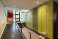 a hallway with green and yellow walls and a staircase at Stayokay Hostel Amsterdam Vondelpark in Amsterdam