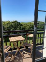 a picnic table and two chairs on a balcony at Amama Baita in Urrugne