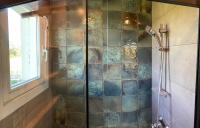 a bathroom with a shower with a glass wall at Amama Baita in Urrugne