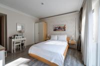 A bed or beds in a room at Elanaz Hotel